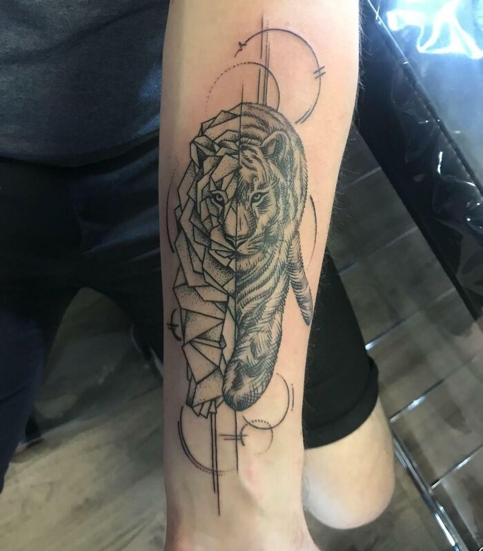 Geometric tattoo of a half-abstract tiger design on an arm, showcasing creative use of shapes and forms.