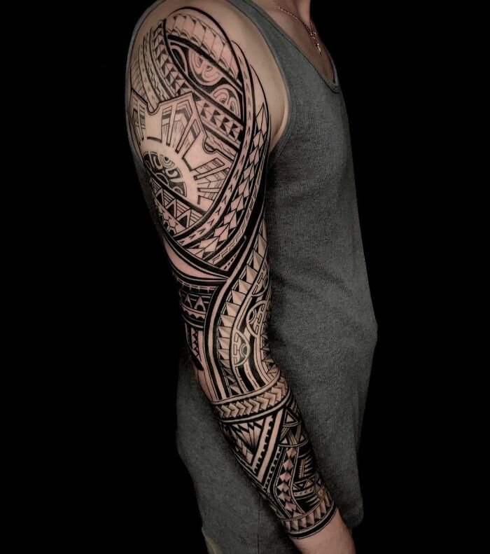 Sleeve with intricate geometric tattoo design featuring various shapes and patterns, highlighting creativity in body art.