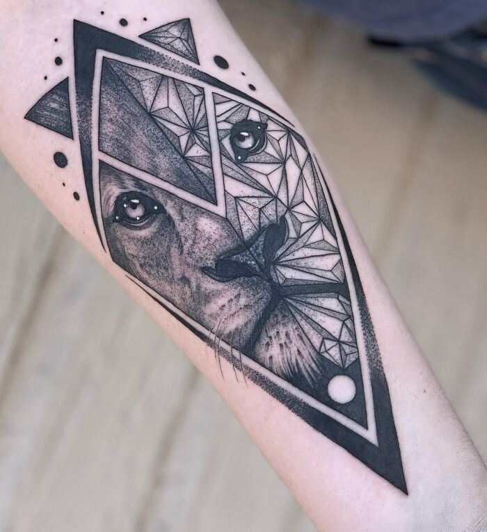 Geometric tattoo design of a lion on an arm, blending intricate shapes and creative patterns.