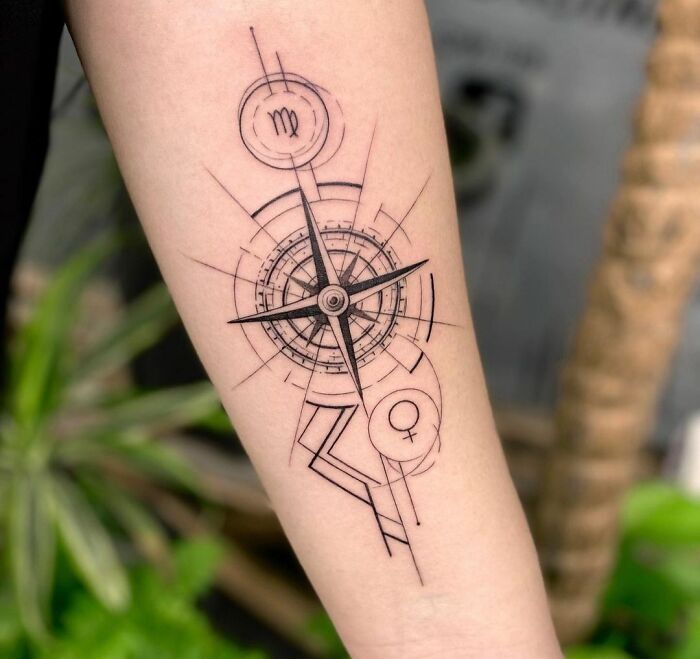 Geometric tattoo with compass design on forearm.