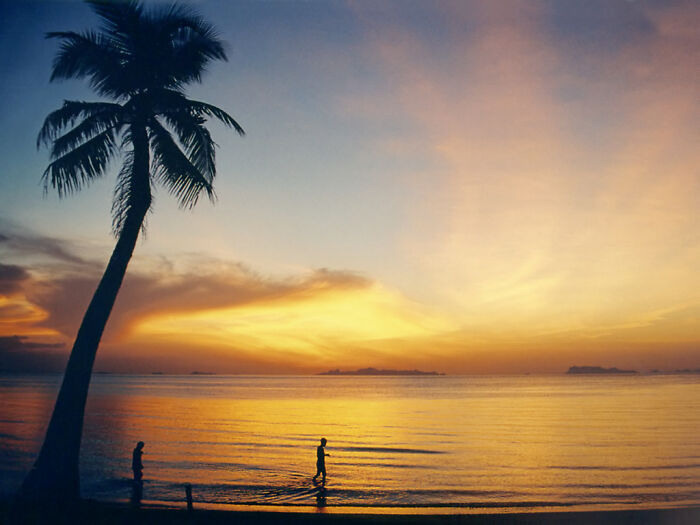 People walking at sunset in Koh Samui
