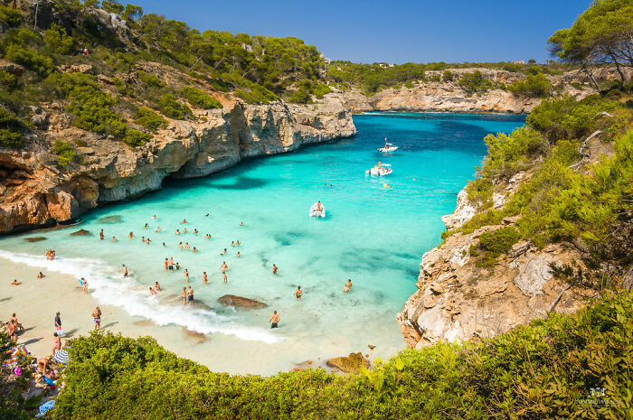 Beach with people and mountains near in Mallorca