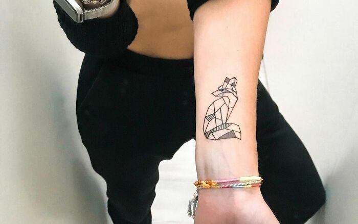 Geometric tattoo of a fox on a person's forearm, showcasing creative line work.