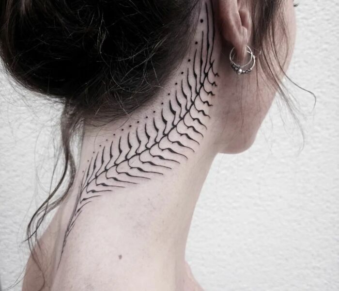 Neck tattoo featuring geometric design with lines and dots, showcasing artistic creativity and form.