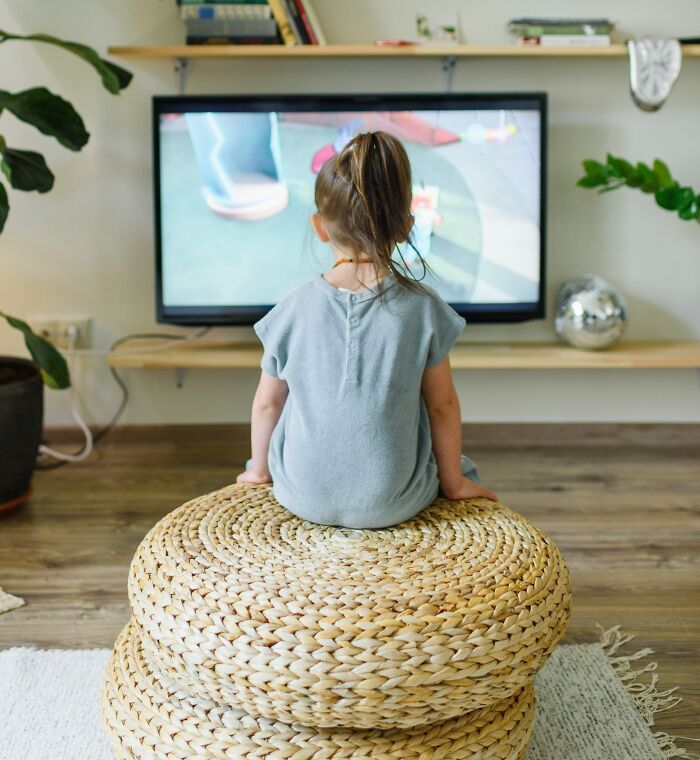 Girl Sitting In Front Of The TV 