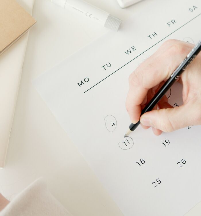 Person Marking Certain Dates On Calendar 