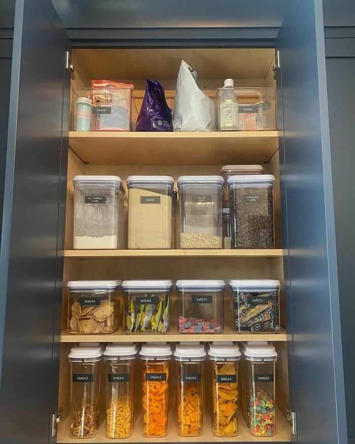 Organized pantry with labeled containers for snacks and baking ingredients.