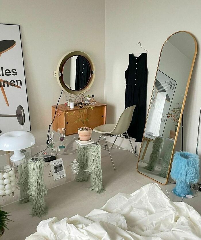 Stylish bedroom setup with mirror, modern furniture, and indoor plants showcasing home organization ideas.