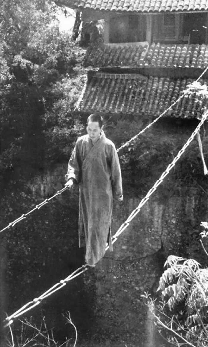 1930s. A Chinese Buddhist Monk Walking On A Chain Bridge At Jiangyou Figure Hill Temple In China