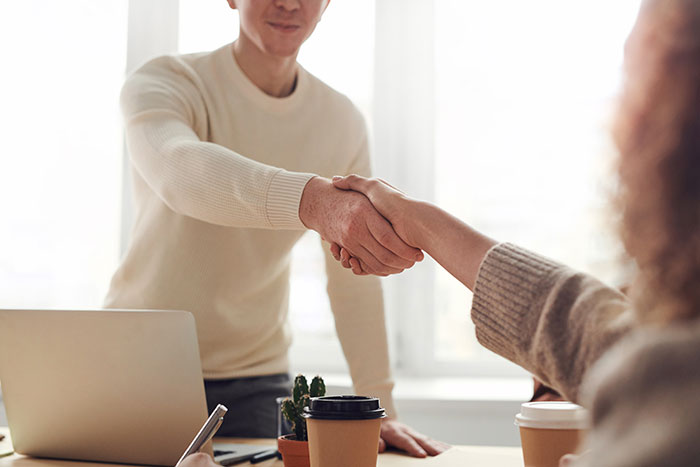 Man and woman holding each other hands near table