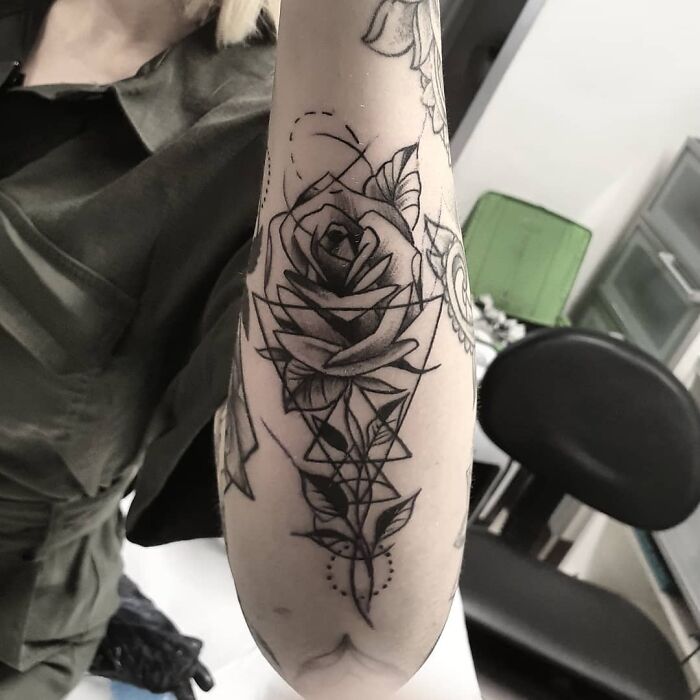Arm tattoo featuring geometric shapes and a rose design, ideal for geometric tattoo inspiration.