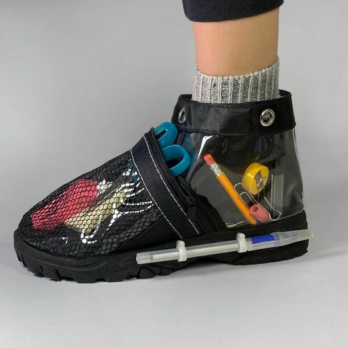 Weird shoes with transparent compartments, holding office supplies like pens, scissors, and a pencil.