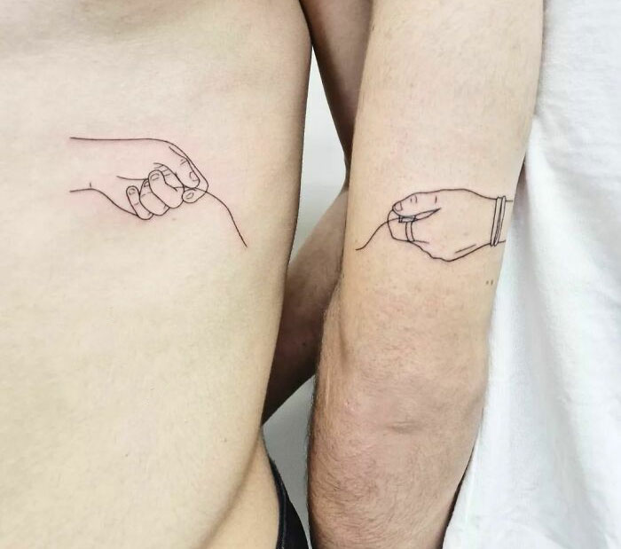 Brother and sister tattoos showing two hands connected by a thread, symbolizing a deep bond.
