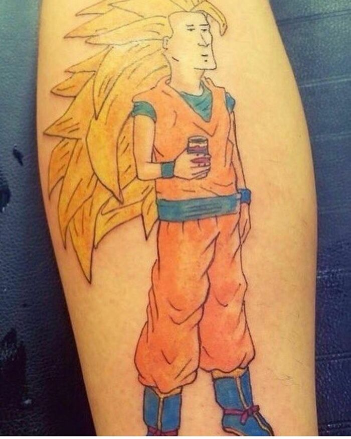 Tattoo of a character with spiky hair and an unimpressed face, illustrating a poorly thought-out tattoo design.