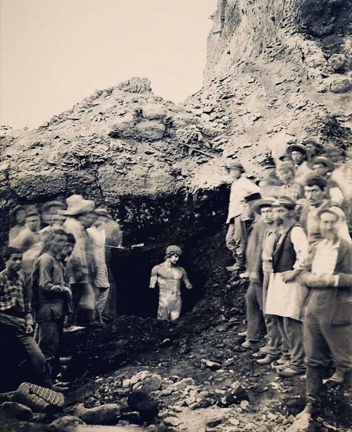 1894. Archaeologists And Workers Pose In Front Of The Near-Perfectly Preserved And Still-Upright Statue Of Antinous, Unearthed Near The Temple Of Apollo In The Sanctuary At Delphi, Greece