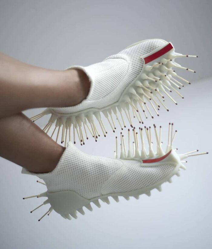 Unusual shoes with white mesh design and protruding spikes, showcasing weird footwear styles.