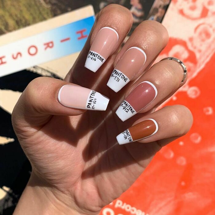 Nail art with Pantone color swatches on each nail, featuring neutral and earthy tones for trendy nail designs.