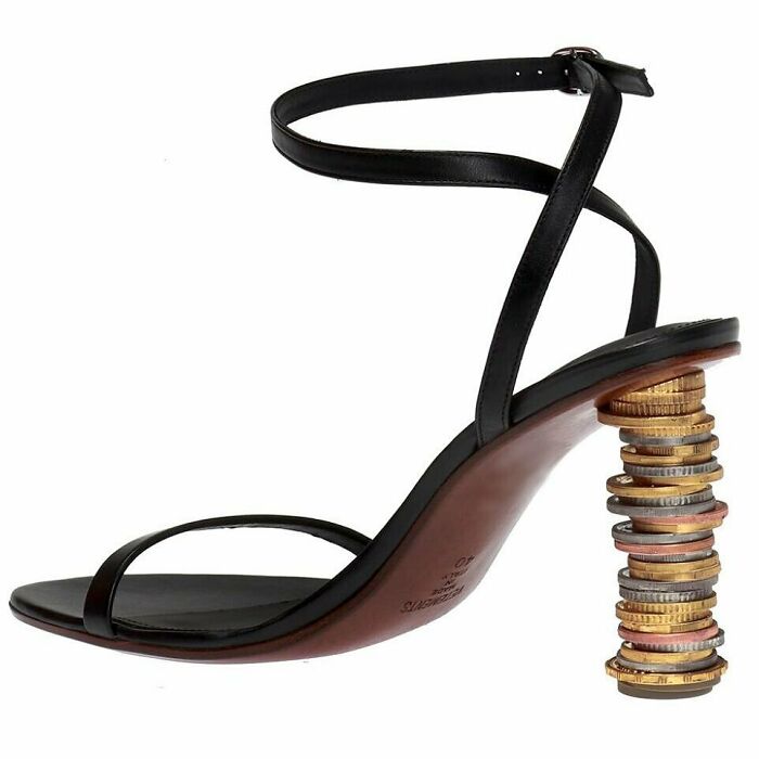 Weird shoe featuring a black strap design with a heel made of stacked coins.
