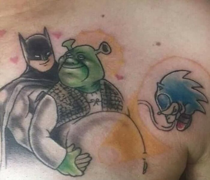 Batman and Shrek tattoo with Sonic beside them, showcasing a humorous design.