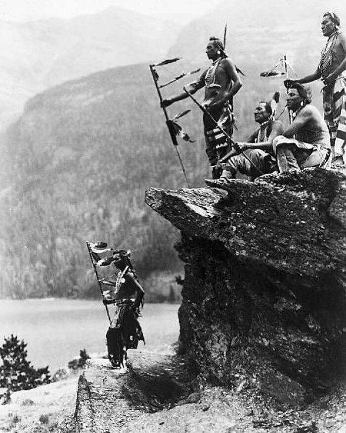 C. 1910. Native American Blackfoot Warriors At Glacier National Park, On The Shore Of St. Mary Lake, Montana. Photo By Roland W. Reed