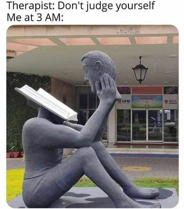 A sculpture of a person holding their head, with a book as a face, humorously illustrating a self-judging meme.