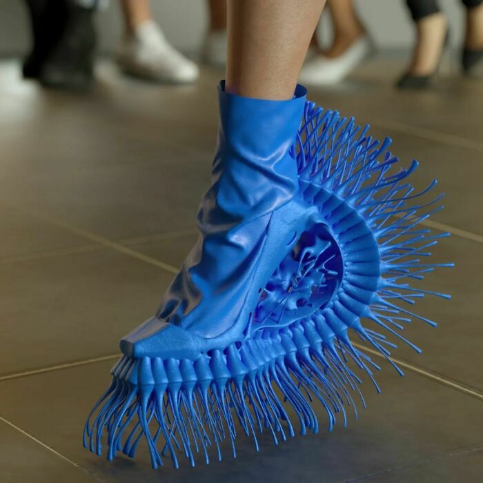 Weird blue shoe with intricate, spiky design.