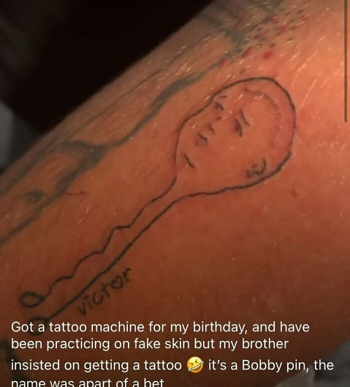 Horrible tattoo of a simple face with "victor" written underneath on an arm, showing poor decision-making skills.