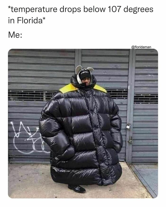 Person in oversized puffer jacket humorously represents Florida's temperature drop below 107 degrees.