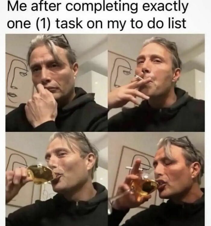 Man in black hoodie celebrates completing a task with a drink and cigarette, illustrating a therapy meme.