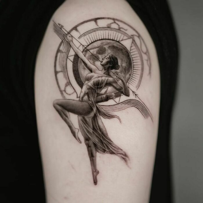 Dancer tattoo design with geometric shapes and circular form on arm, showcasing creativity in geometric tattoos.