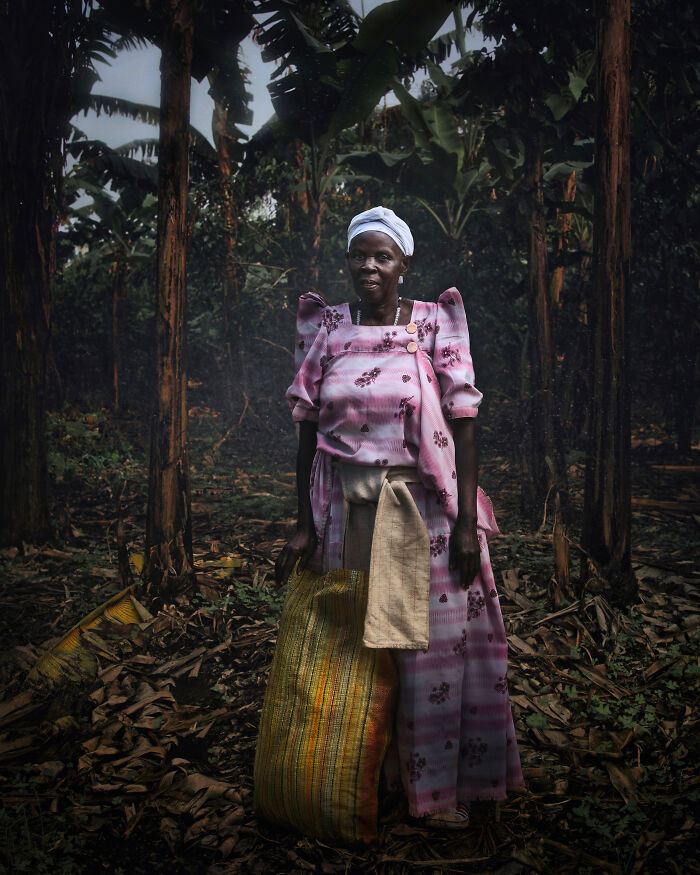 Woman breaking stereotypes standing in a forest holding a large sack, representing empowerment and strength.