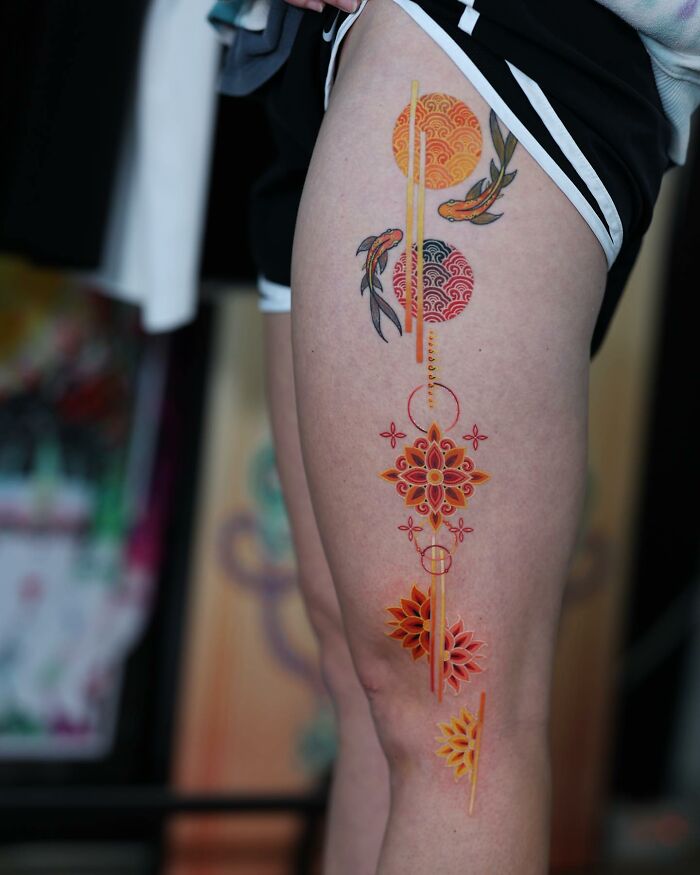 Korean artist's mesmerizing tattoo with intricate geometric and koi fish design on a person's thigh.