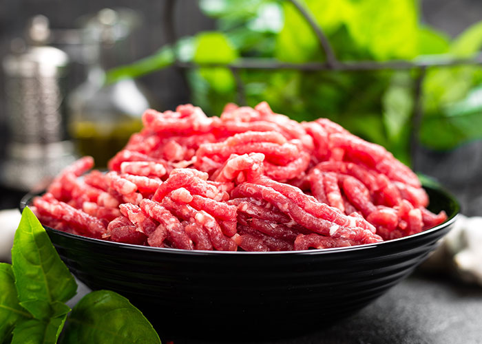 Raw ground meat in a bowl representing American cuisine and foods banned in other countries but consumed in the US.