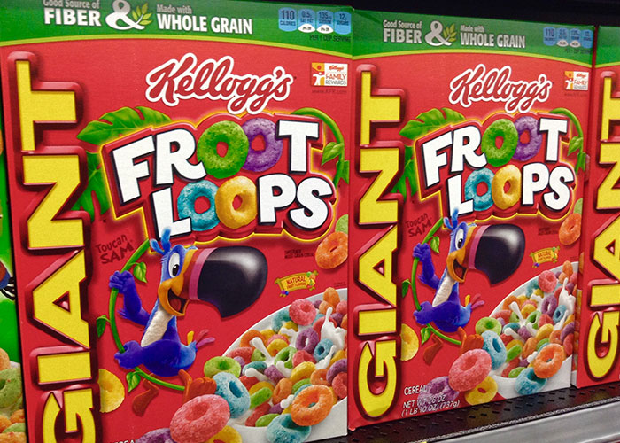Boxes of Kellogg's Froot Loops cereal on a store shelf highlighting dark side of American cuisine and banned foods.