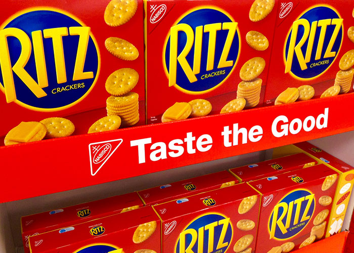 Ritz crackers displayed on a store shelf highlighting American cuisine and banned foods in other countries.