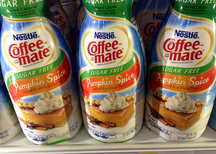 Bottles of sugar free pumpkin spice Coffee-mate creamer highlighting dark side of American cuisine and banned foods.