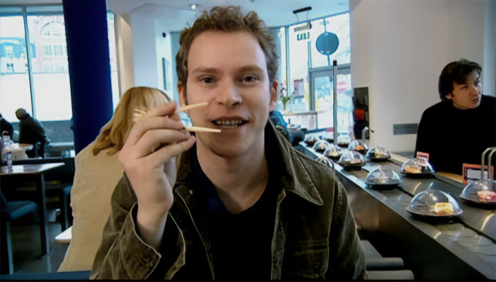 Jeremy Usborne holding chopsticks