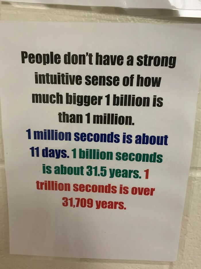 Absurd sign explaining how much bigger 1 billion seconds is than 1 million, highlighting funny and confusing comparisons.