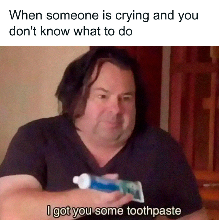 Man awkwardly offering toothpaste with caption about not knowing what to do when someone is crying, introvert friends meme.