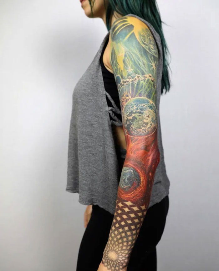 Colorful geometric tattoo sleeve featuring intricate shapes and patterns on a person's arm.