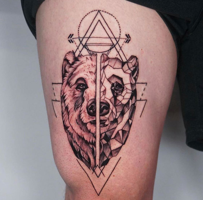 Geometric tattoo of a bear, featuring intricate line work and abstract patterns on the thigh.