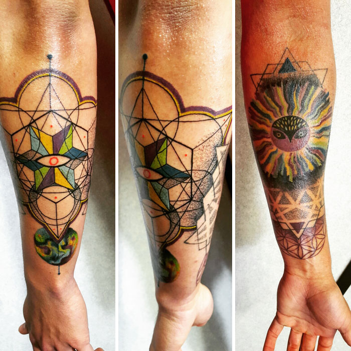 Geometric tattoo design featuring colorful shapes and intricate forms on a person's arm.