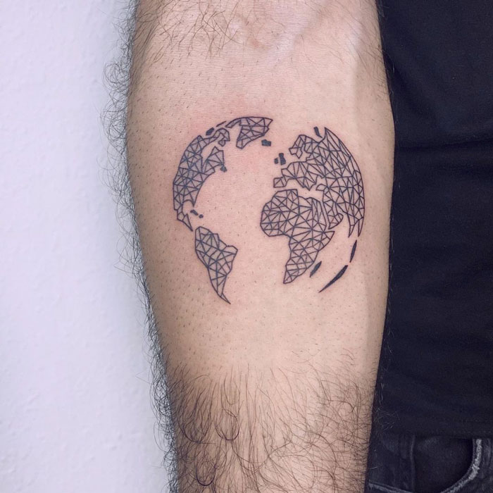 Geometric tattoo of a world map on an arm, featuring intricate triangular patterns.