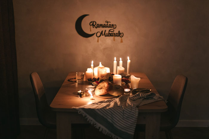 Dinner placed on the table with lighted candles