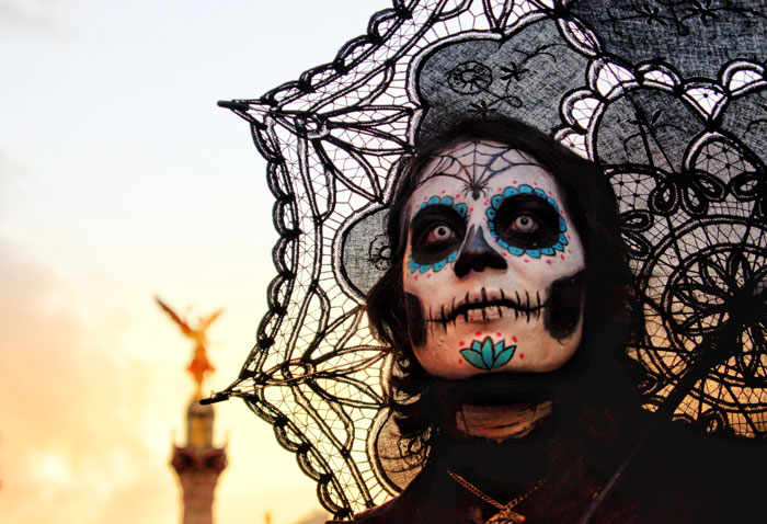 Person with skull face paint and black umbrella 