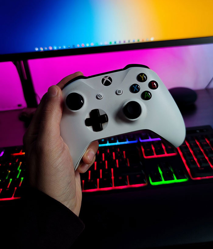 Person holding gaming controller