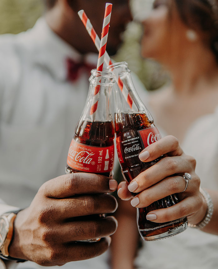 Person holding Coca Cola drinks