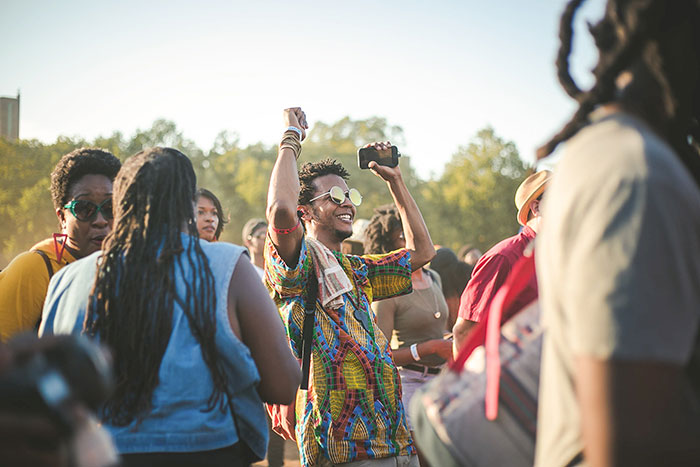 Person dancing and smiling at the concert
