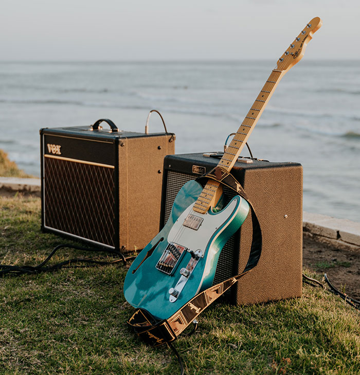 Blue electric guitar near audio equipment