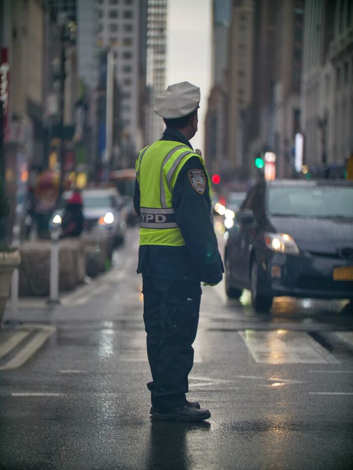Police Man Regulates The Traffic In Streets 